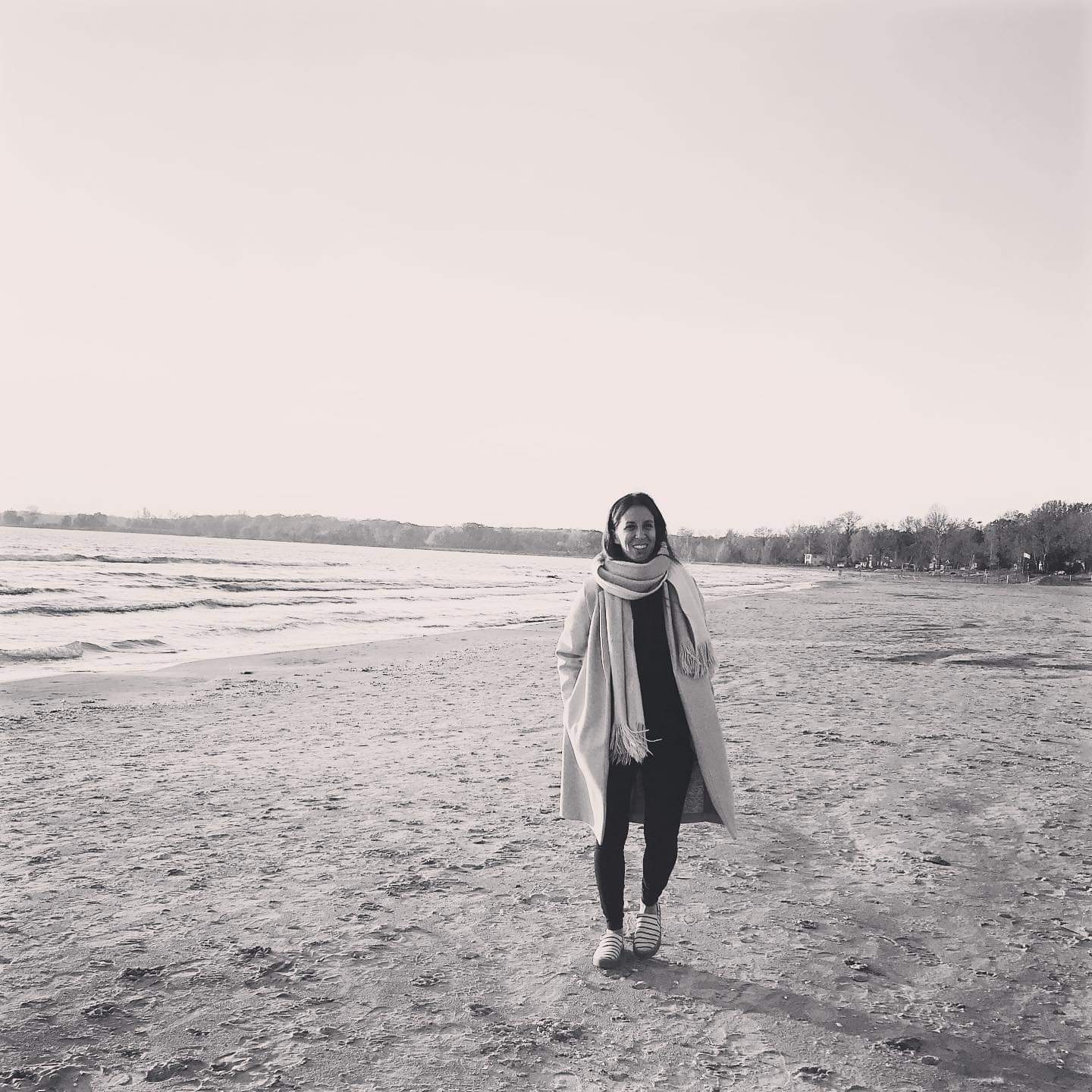 Image of Melaina Gasbarrino walking along the shore